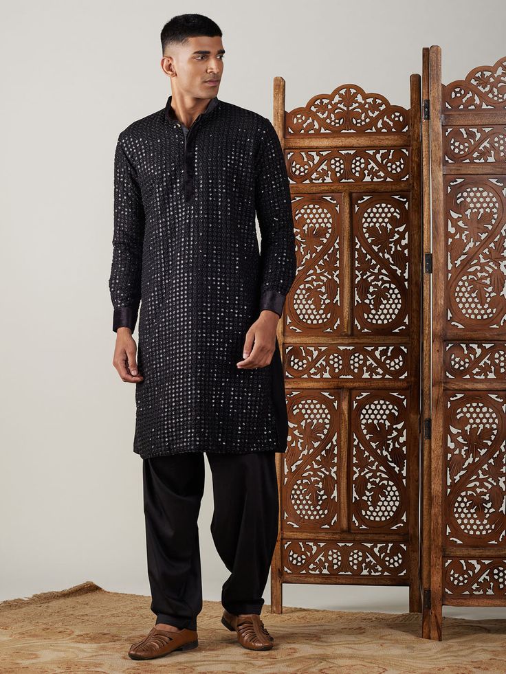 Vastramay Men's Black Mirror Georgette Kurta With Patiala Set Make a statement in this elegant black kurta with a stylish mirror work design. The georgette fabric adds a touch of luxury, perfect for festive occasions or special events. Features: Black georgette kurta with mirror work Patiala set for a complete traditional look Comfortable and stylish Specifications: Brand: VASTRAMAY Color: Black Fabric: Georgette Neck: Mandarin Collar Sleeve Length: Full Sleeves Material & Care: Georgette, Dry-c Mirror Work Design, Intricate Mirror, Georgette Kurta, Stylish Mirror, Black Kurta, Kurta Pant Set, Kurta Pyjama, Elegant Mirrors, Comfortable Pajamas