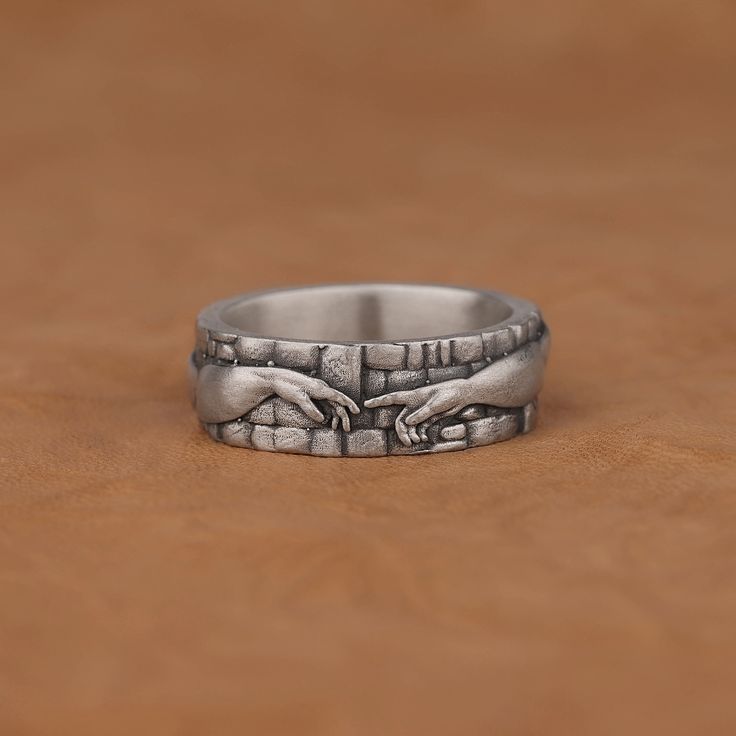 The Creation of Adam Ring, Realistic Handmade Silver Art Ring for Him, Unique Statement Ring, Oxidized Sterling Silver Mens Engagement Ring Made of 925 silver and handcrafted by hand, this ring is not only an accessory piece that complements your daily elegance, but also has details that will reflect your character and style. It is also a great gift to give to your loved ones on their special days. At SavisSilver, we always give importance to the satisfaction of our customers, we recommend you t Unique Stainless Steel Promise Ring, Symbolic Adjustable Ring With Unique Design, Symbolic Metal Promise Ring, Symbolic Rings With Unique Design For Gift, Symbolic Hand Cast Adjustable Rings, Handmade Stainless Steel Rings For Anniversary, Handmade Symbolic Promise Rings, Symbolic Metal Ring As A Gift, Symbolic Metal Rings As Gifts