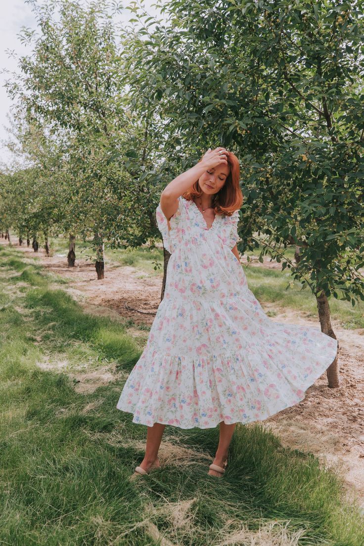 This flirty Take Me Back Dress is the perfect way to add some floral fun to your wardrobe. With a flattering V-neckline and playful ruffle details, you'll turn heads wherever you go. Don't miss out on this must-have piece. Details Floral pattern V-neckline Ruffle details Sizing Approximate measurements: SIZE LENGTH BUST Small 47" 38" Medium 48" 40" Large 49" 42" Fabric has no stretchModels are 5’10 wearing small Material 100% CottonHand wash coldHang to dry Ditsy Floral Print V-neck Dress For Garden Party, Flirty V-neck Midi Dress With Ruffle Hem, Feminine V-neck Dress With Ruffles And Short Sleeves, Summer V-neck Ruffle Dress For Brunch, Summer Floral V-neck Dress With Ruffles, Flirty V-neck Spring Dress, Spring Tiered V-neck Dress With Ruffles, Flirty V-neck Dress With Ditsy Floral Print, Spring Vacation V-neck Dress With Flutter Sleeves