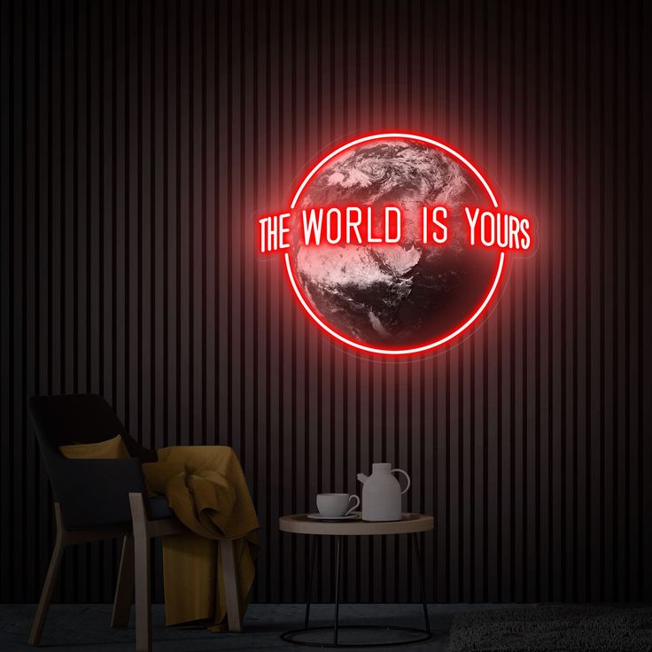 the world is yours neon sign in a dark room with a table and chair next to it