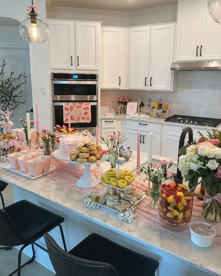 a kitchen filled with lots of food on top of a counter next to a stove