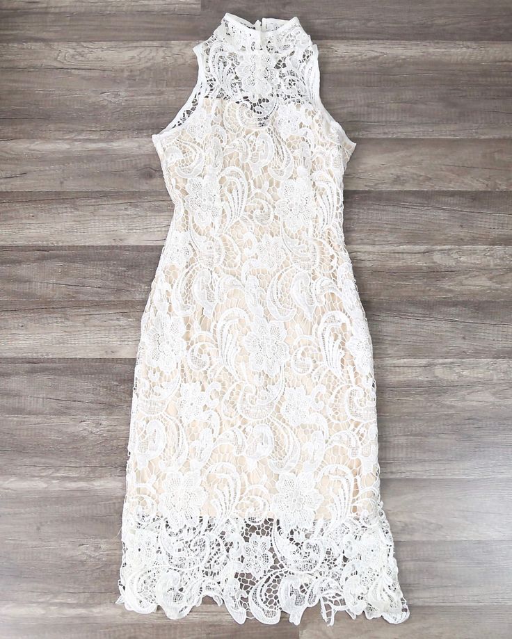 Loves Divine Midi Dress Polyester lace midi dress High neck Keyhole back Button closure on neck Beige lining Split at back This midi dress is so stunning in the white lace. With the high neck and open back, it’s classy yet sexy – the perfect party dress. Wear it with heels and a red lip – what’s not to love? SKU: L088- Chic White Midi Dress With Lace Bodice, White Knee-length Dress With Lace Bodice, White Midi Lace Dress With Scalloped Lace, White Midi Dress With Lace Bodice, White Scalloped Lace Midi Dress, Lace Back Midi Lace Dress, White Feminine Dress With Lace Back, Feminine White Dress With Lace Back, Elegant White Midi Dress With Lace Top