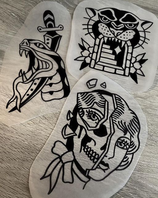 three black and white stickers with cats on them, one in the shape of a skull