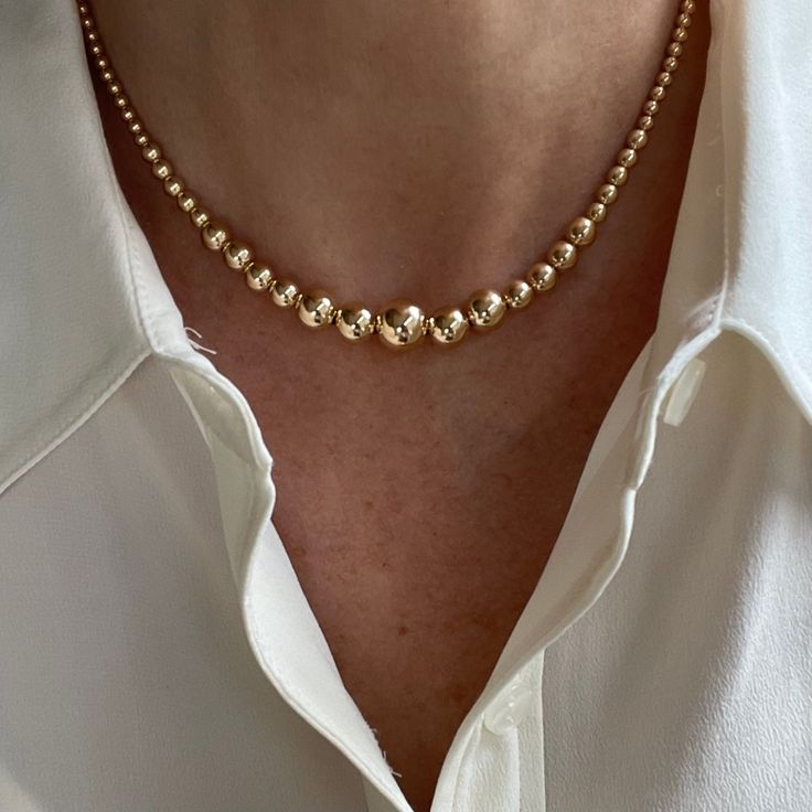 "This stunning graduated necklace is crafted with 14K yellow gold filled round beads from 4-10mm.   The overall design results in a well balanced piece of modern charm that is rich looking yet conservative in appearance, worthy of any occasion.  We offer this necklace in lengths from 14\" up to 18\" AND as a set of three necklaces as shown in the photos: Set 1: 14\" Graduated Gold Filled Necklace 16\" 3mm Round Pearl Necklace 18\" 3.1mm Gold Filled Paperclip Necklace Set 2: 16\" Graduated Gold F Luxury Formal Chain Necklace With Round Beads, Cheap Gold Crystal Necklace With Round Beads, Luxury Gold Crystal Necklaces With Round Beads, Luxury Delicate Chain Necklace With Round Beads, Luxury Gold Bridal Necklace With Round Beads, Luxury Classic Yellow Gold Beaded Necklace, Luxury Classic Necklace With Gold Beads, Luxury Gold Beads Necklace For Celebration, Luxury Gold Plated Necklaces With Round Beads