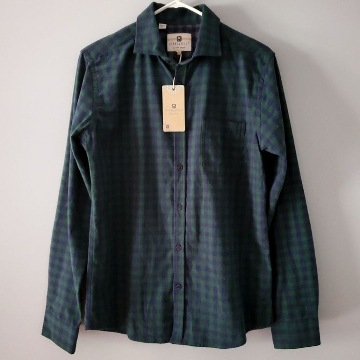 Introducing The Stylish Steel & Jelly Hunter Green|Navy Blue Button-Down Long-Sleeve Shirt In Size M. This Shirt Comes From The Highly Popular Brand M & M. It Is An Excellent Piece Of Clothing For Casual Outings And Formal Events Alike. The Shirt Is Made With High-Quality Materials And Is Designed To Fit Regular-Sized. The Shirt Comes In A Navy Blue And Hunter Green Color Flannel Style. 52% Polyester 48% Cotton Chest: 21.5" Length: 28 Sleeve: 25.5" Size: M New With Tags Green Long Sleeve Flannel Shirt For Work, Blue Flannel Shirt With Buttons For Work, Blue Buttoned Flannel Shirt For Work, Green Cotton Flannel Shirt For Work, Green Cotton Flannel Workwear Shirt, Blue Button-up Flannel Shirt For Work, Green Long Sleeve Shirt For Business Casual, Fitted Collared Flannel Shirt For Workwear, Navy Shirt With Button Closure For Fall