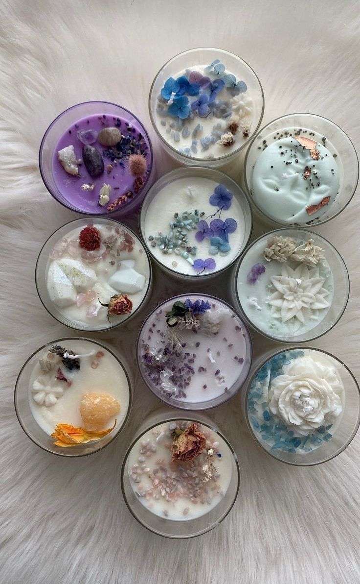 six glass bowls with different types of flowers in them on a white furnishing