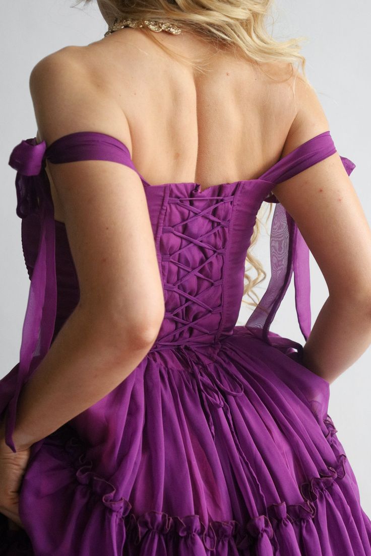 Orders ship out approx 1-3 days after purchase. Transit times approx 3-5 days for US destinations. Our signature Siena is THE main character dress. Siena features a three tier dress in the perfect shade of dark jewel-tone purple.The bust features V shaped corset boning that gives a flattering look. The Siena features a functional corset back closure that you can tighten for a snatched bodice look, adjusting the bust and the waist, helping you get the perfect fit every time. The scooped neckline Purple Ruffled Gown For Party, Purple Party Gown With Ruffles, Purple Sleeveless Ruffled Gown, Purple Ruffled Prom Dresses, Purple Ruffled Wedding Dresses, Purple Ruffle Wedding Dresses, Purple Ruffled Ball Gown Dress, Purple Ball Gown Dresses With Ruffles, Purple Evening Gown With Pleated Bodice