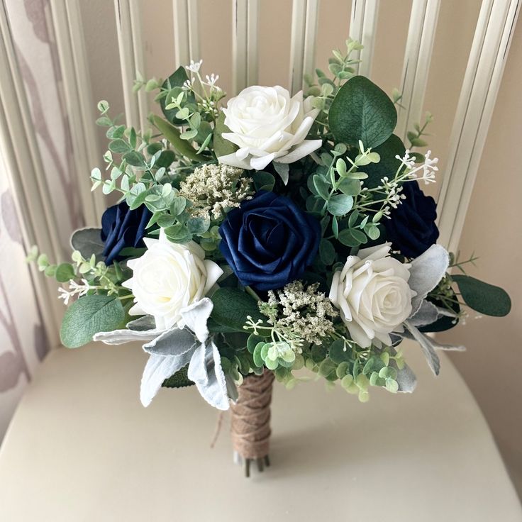 a bouquet of white and blue flowers on a chair