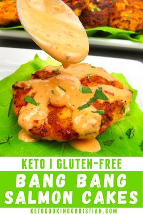 keto gluten - free bang bang salmon cakes on a leaf with sauce being drizzled over the top