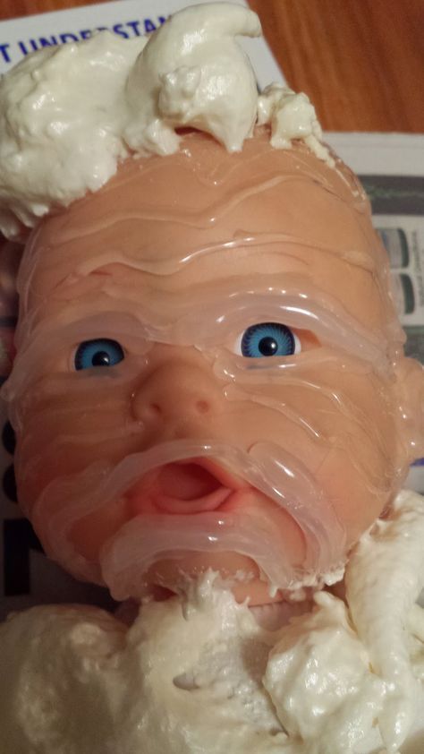 a baby doll that is covered in icing