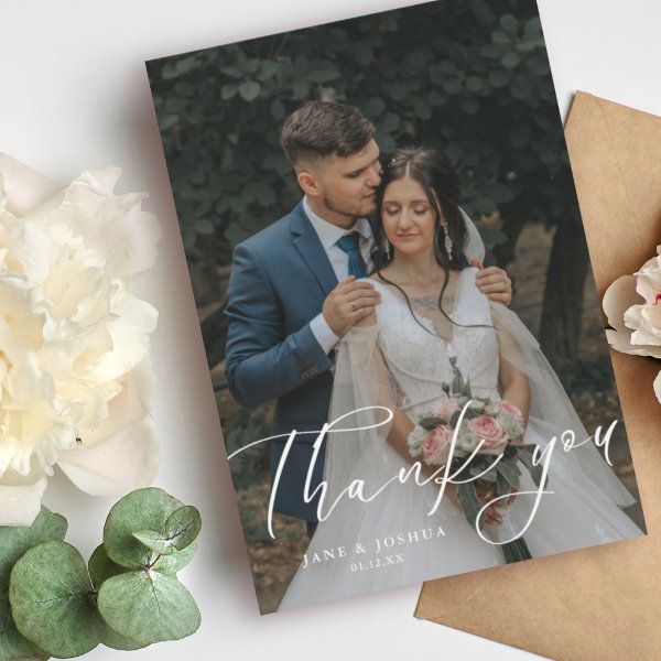 a wedding thank card with the words thank you on it next to flowers and succulents