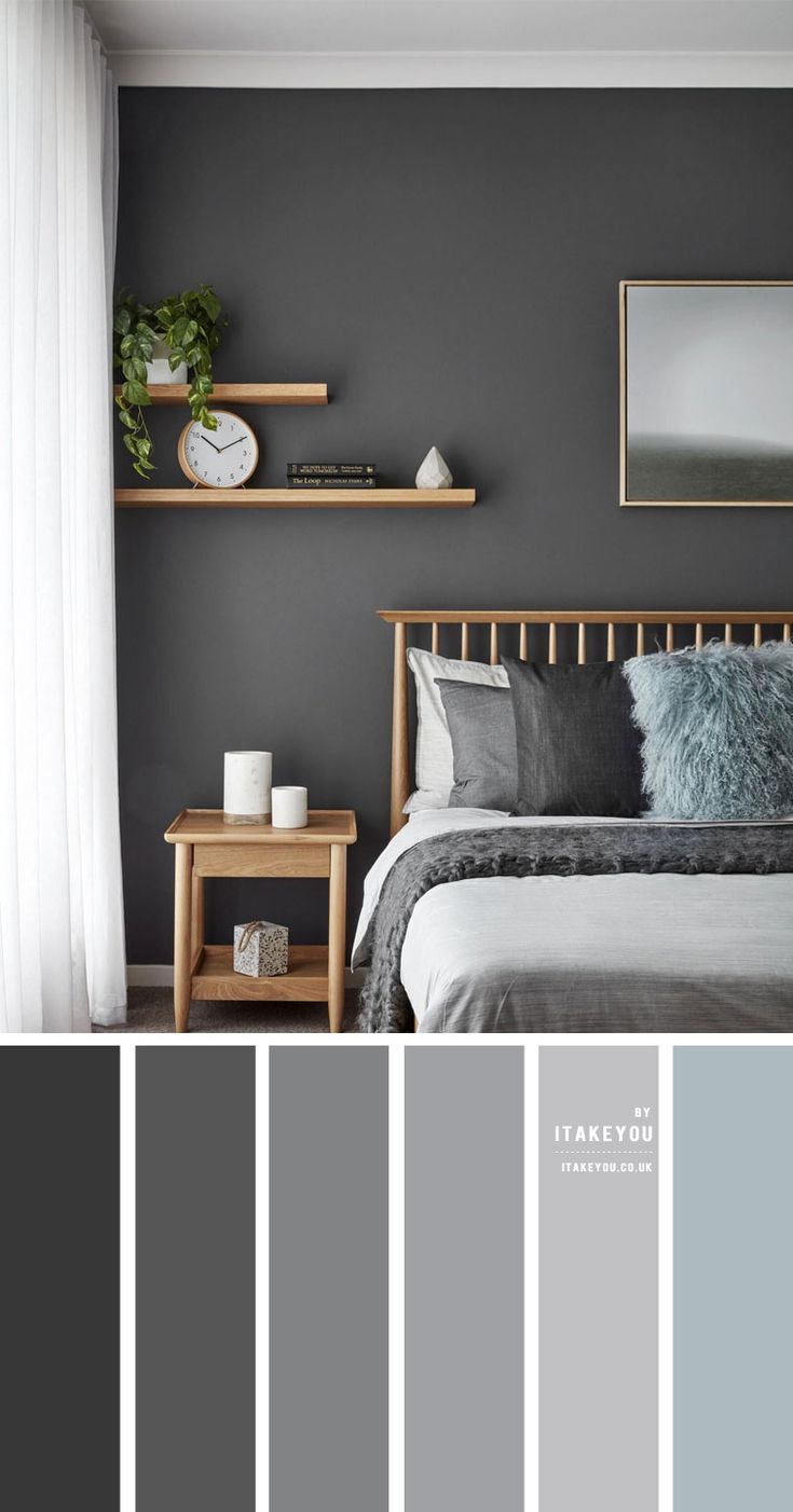 a bedroom with gray walls, white curtains and grey bedding in the center is a wooden