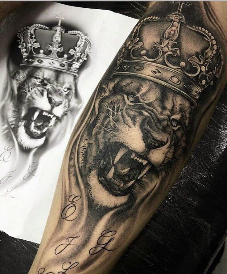 a tiger with a crown on his head next to a tattoo