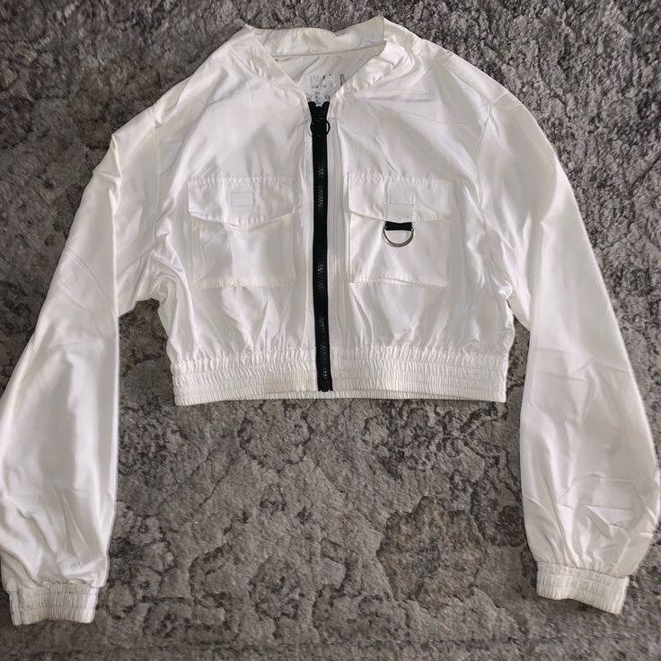 Nylon Material Windbreaker, Size S For Juniors And Is Cropped, It’s Very Comfortable And Stretches A Bit. From H&M White Stretch Tops With Pockets, Spring Nylon Tops With Pockets, Casual White Nylon Outerwear, Casual Cropped Nylon Outerwear, Chic White H&m Outerwear, White Fitted Outerwear By H&m, H&m Casual Summer Outerwear, H&m White Spring Outerwear, White Casual Nylon Tops