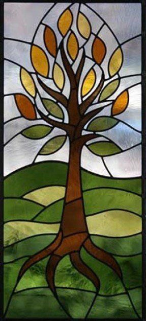 a stained glass window with a tree on it