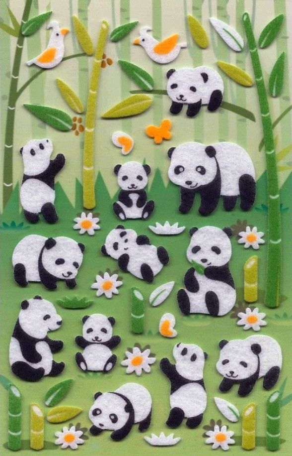 the panda bears are playing together in the grass with flowers and bamboo trees behind them