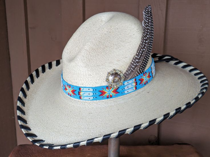 The Renegade Gus Palm Hat has a 4" brim and 5 1/2" crown. Super comfortable with a sweat band on the inside. Hand laced in black leather lace. Beautiful blue beaded hatband is secured on the hat and the back of the band has a deer antler bead. Accented with a Concho and Guinea feathers. Note: Hats are made to order. Please allow up to 4 weeks for your hat to ship Adjustable Wide Brim Costume Hats For Western-themed Events, Adjustable Costume Hats With Short Brim For Western Events, Adjustable Costume Hat For Western-themed Events, Western Adjustable Costume Hat With Short Brim, Adjustable Western Costume Hat With Short Brim, Adjustable Costume Hat With Curved Brim For Western-themed Events, Adjustable Brimmed Top Hat For Western-themed Events, Western Costume Hat With Adjustable Curved Brim, Western Adjustable Costume Hats And Headpieces For Country Events