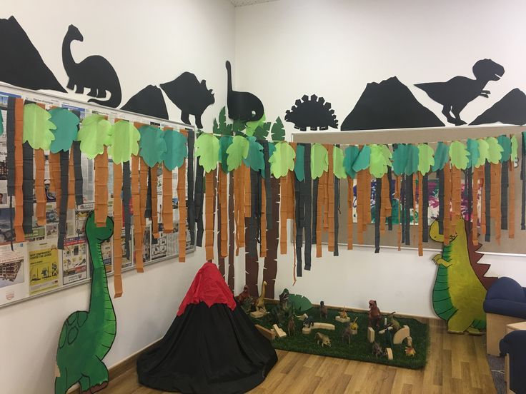 the room is decorated with dinosaurs and trees