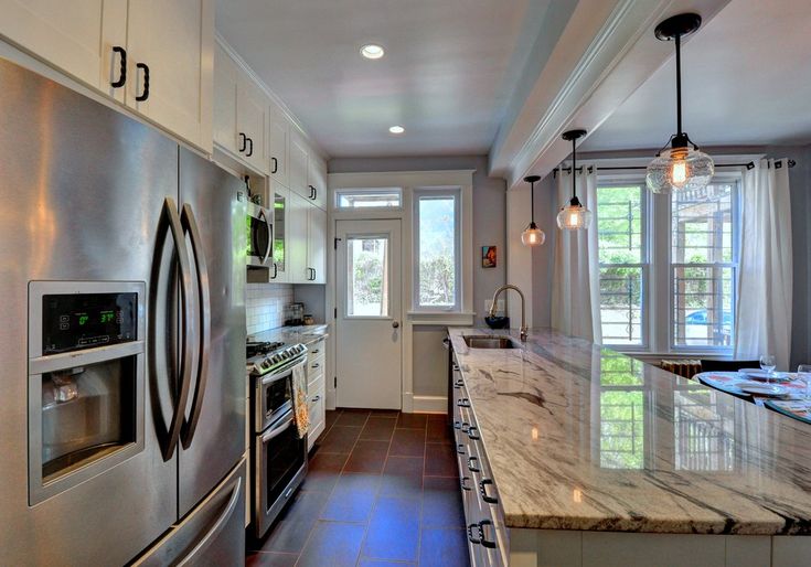 a kitchen with marble counter tops and stainless steel appliances