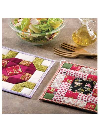 a bowl of salad next to two quilted placemats and a glass dish holder