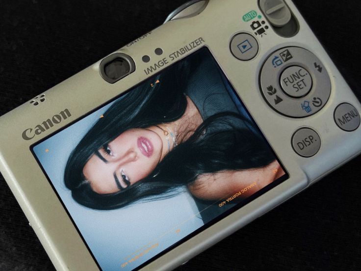 a digital camera with an image of a woman on the screen