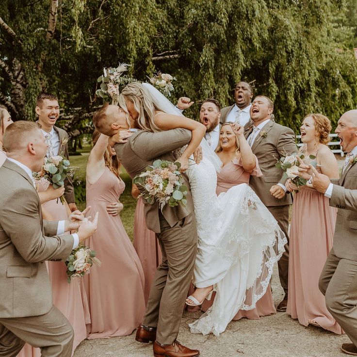 a bride and groom are surrounded by their wedding party