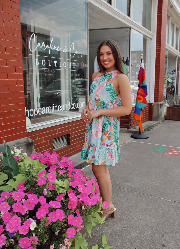 This cute ruffled mini dress will set off a fashion trend and have you feeling totally refreshed. We love its sleeveless, frilled mock neck with a lace-up design at the back, and the high-quality fabric. Its pretty floral print is one of the most popular fashion elements at the moment. This dress looks good with sandals, high heels, or flats. This will be your go-to dress of the summer. 90% Polyester, 10% Elastane. Sizing runs true. Model is wearing a size small. Multicolor Ruffled Knee-length Mini Dress, Summer Knee-length Mini Dress With Vibrant Print, Floral Print A-line Mini Dress For Vacation, Light Blue Floral Print Knee-length Mini Dress, Sandals High Heels, Ruffled Mini Dress, Beach A-line Mini Dress With Ruffle Hem, Fashion Elements, Dress Looks