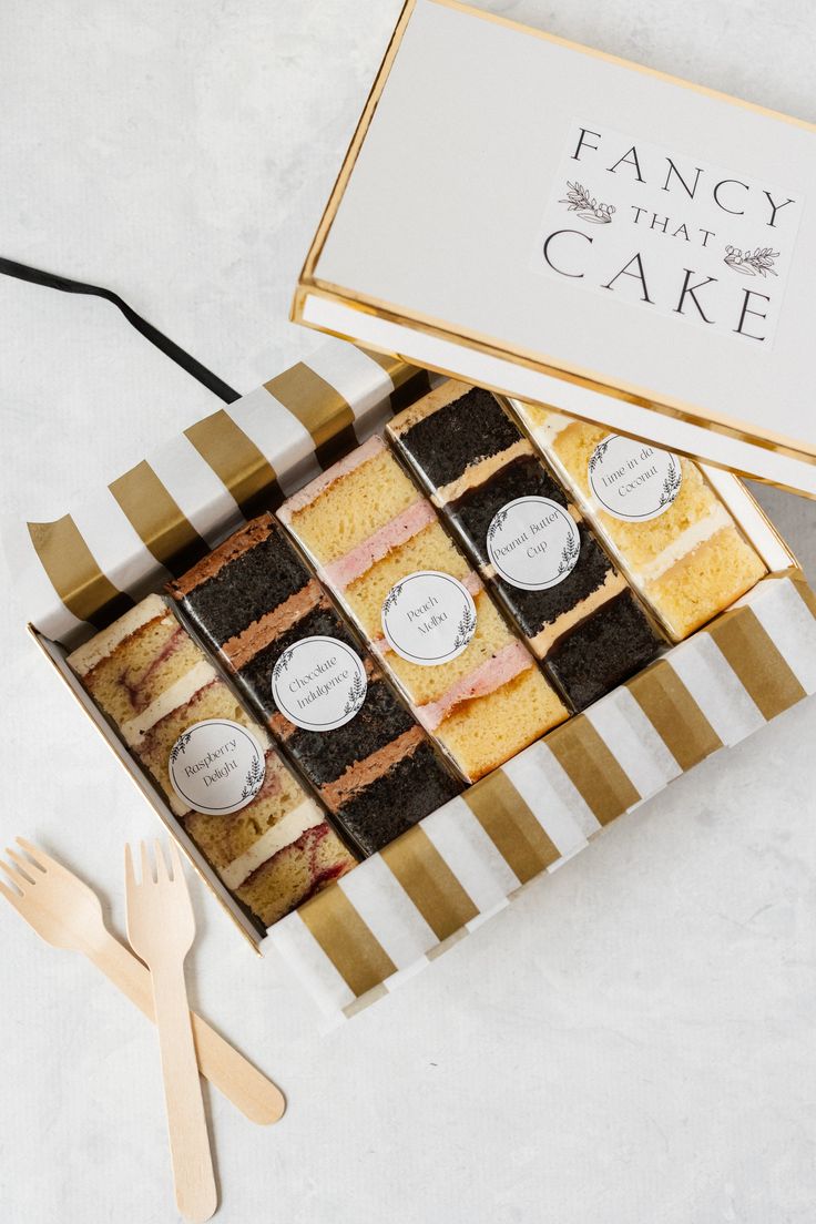 fancy that cake is in a box with utensils