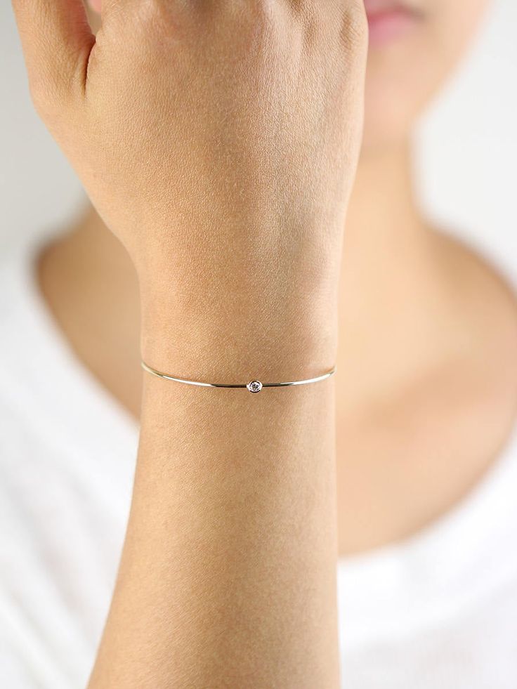 JSVConcepts Fine Jewelry Diamond Bangle Bracelet, Diamond Solitaire Bangle Bracelet, Minimalist Bracelet, 14K Gold Bangle Bracelet, Diamond Bracelet, Gift for her ≫ Product Details ◈ Handmade / Handcrafted Fine Jewelry ◈ Diamond: 100% Natural Diamond ◈ Diamond Weight: 0.07 ct. (2.60 mm) ◈ Color: G Color ◈ Clarity: VS-SI ◈ Cut: Brilliant Cut ◈ Bangle Thickness: 1.30 mm ◈ Metal: Solid 14K Gold (18K also available - Additional fees may apply) ◈ Gold Color: White gold, Rose gold, Yellow gold ≫ Pleas Minimalist Stackable White Gold Bracelets, Minimalist White Gold Stackable Bracelets, Minimalist Bracelet Strap For Anniversary, Adjustable Dainty Diamond Bangle Bracelet, Dainty Adjustable Diamond Bangle Bracelet, Gold Sterling Silver Bracelet For Anniversary, Gold Sterling Silver Bracelet For Anniversary, Minimalist Style, Minimalist White Gold Jubilee Bangle, Dainty Adjustable Diamond Bracelet With Strap