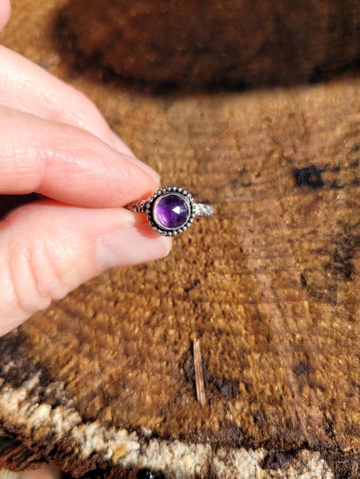 Datk purple amethyst gemsyone ring. You won't be disappointed! Rich dark purple hues are stunning! I hand make all my rings with great detail.   These rings are made to order and can take 2 weeks to ship out but I usually start the process within 1-2 days Elegant swirl design in the ring shank Have any questions please ask me Purple Sterling Silver Promise Ring, Purple Amethyst Ring With Sterling Silver, Adjustable Amethyst Ring With Stone Setting, Purple Amethyst Ring In Sterling Silver, Purple Amethyst Ring With Round Stone For Gift, Lavender Amethyst Ring With Birthstone, Purple Amethyst Ring With Accent Stones, Adjustable Amethyst Ring With Gemstone Accents, Handmade Amethyst Rings In Purple