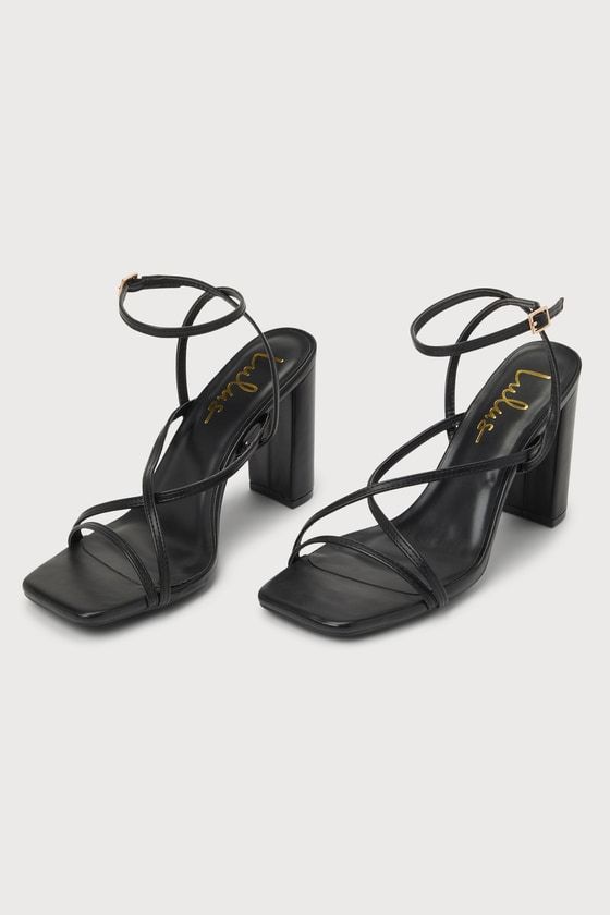 The Lulus Makennaa Black Strappy High Heel Ankle Strap Sandals are the perfect finishing touch to any flirty going-out look! These sleek heels have a smooth faux leather construction that shapes a square toe bed, a slender toe strap, and matching vamp straps that create a crisscrossing effect. An adjustable ankle strap sprouts from the sides and secures with a shiny gold buckle, all atop a chic block heel. 3. 75" wrapped block heel. Cushioned insole. Rubber sole has nonskid markings. Man made ma Chic Ankle Strap Heels With Sculpted Heel, Chic Heels With Sculpted Heel And Ankle Strap, Sleek Ankle Strap Heels For Date Night, Chic Strappy Heels With Heel Strap, Strappy Heels With Sculpted Heel For Night Out, Date Night Heels With Wrapped Block Heel, Elegant Block Heels With Heel Strap For Date Night, Chic Ankle Strap Block Heels With Wrapped Heel, Strappy Heels With Wrapped Heel For Date Night