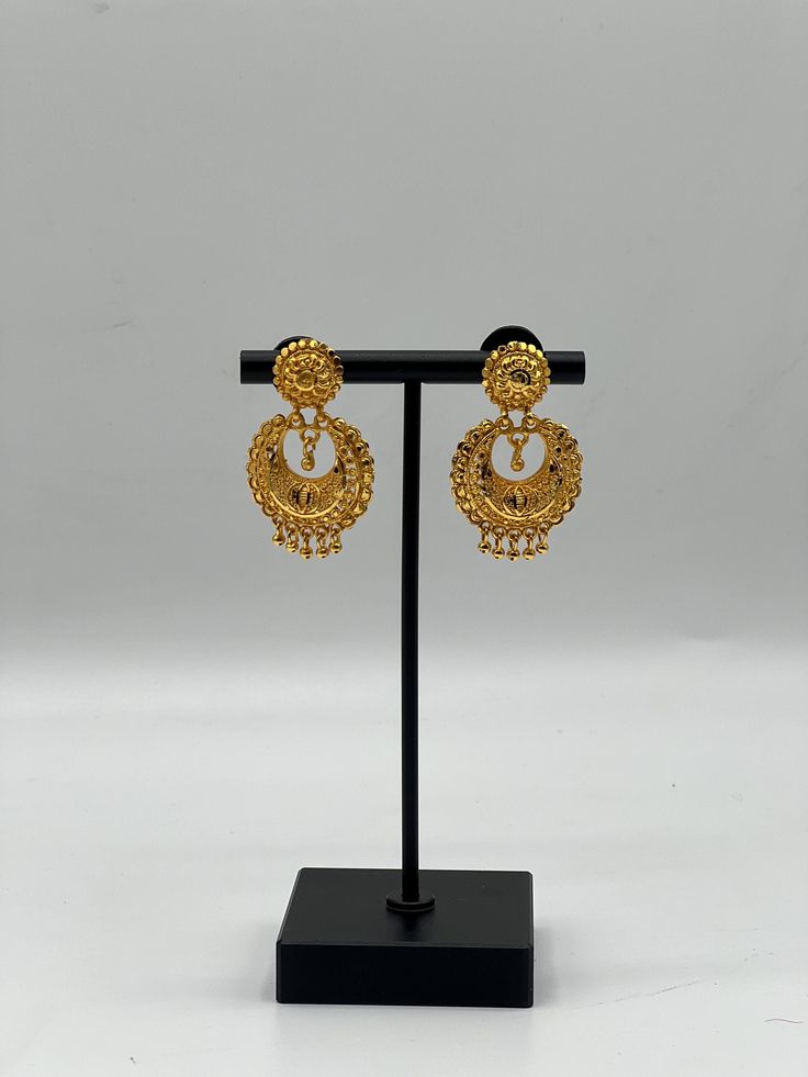 Add a touch of traditional elegance to your jewellery collection with our Gold Plated Jhumka Earrings. These earrings are perfect for making a bold style statement. Why You'll Love It: These Gold Plated Jhumka Earrings are perfect for any special occasion, whether it's a wedding, festival, or a festive party. They add a touch of glamour and traditional charm to any outfit, making you stand out in the crowd. Great Gift Idea: Packaged in a beautiful jewelry box, these earrings make a wonderful gif Elegant Round Earrings For Navratri, Gold Plated Chandbali Bridal Earrings, Festive Chandbali Earrings With Tilla, Festive Chandbali Earrings With Tilla Detail, Festive Tilla Chandbali Earrings, Temple Jewelry Style Round Latkans Earrings, Temple Jewelry Style Gold Plated Drop Bridal Earrings, Gold Earrings With Tilla For Gift, Gold-plated Chandbali Bridal Earrings