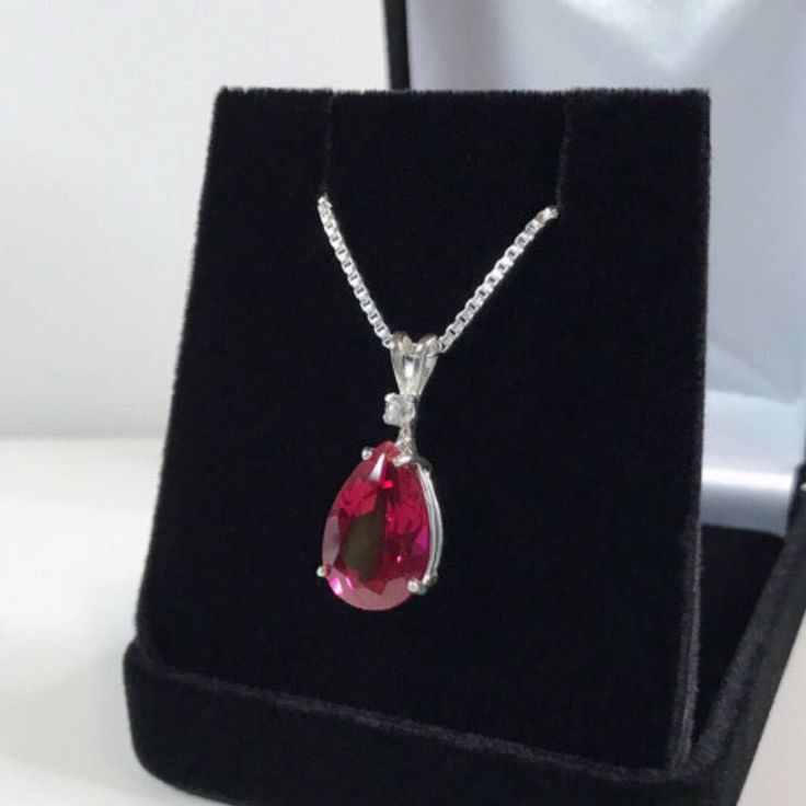 "Beautiful Ruby & White Sapphire Pendant Necklace * Pear Cut Ruby Measures 12mm x 8mm * Single Brilliant Cut White Sapphire Accent * 4cts Total Gemstone Weight * 16\" or 18\" Sterling Silver Chain Included * Solid Sterling Silver - Also available in 14kt Gold (message me for details) Hallmarked & Gift Ready! Matching Earrings & Ring Available This Gorgeous Ruby is laboratory grown. It is identical to the natural stone in every way, including chemistry, composition and hardness, with Oval Drop Necklace Fine Jewelry Gift, Pear-shaped Jewelry For Valentine's Day Gift, Valentine's Day Gift Pear-shaped Jewelry, Pear-shaped Jewelry For Valentine's Day Formal, Fine Jewelry Pear-shaped Drop Necklace As Gift, Pear-shaped Gemstone Jewelry For Valentine's Day, Fine Jewelry Pear-shaped Drop Necklace For Gift, Pear-shaped Gemstone Drop Necklace For Anniversary, Pear-shaped Fine Jewelry Drop Necklace For Gift