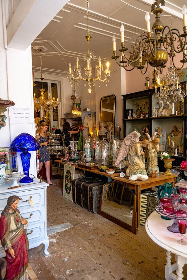 a room filled with lots of glassware and figurines on top of tables