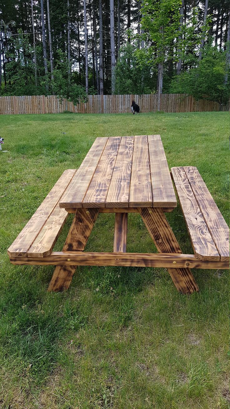 a picnic table made out of pallets in the grass