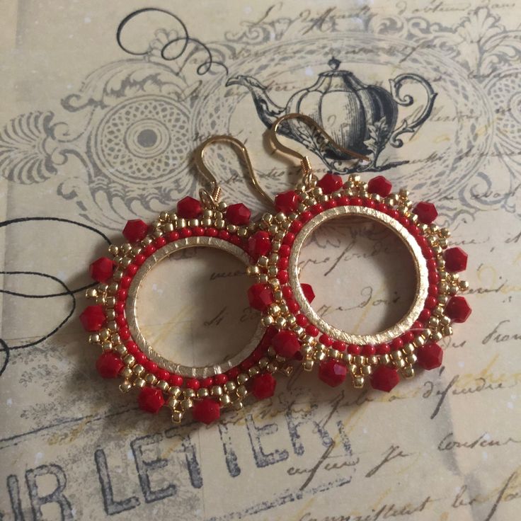 Red Crystal Seed Bead Hoop Earringsp Hoop earrings made with bright red velvety crystals with metallic gold 11/0 beads. The perfect Christmas holiday season earrings. Beautiful red crystals bead woven on a gold plated ring. The french hook earwires and findings are 14kt gold plated. These very lightweight measure 1.75 inches total. The beaded hoops are slightly over 1 inch. Great for anytime. I absolutely love this color and sparkle. Thanks for looking and please stop by again. 8 Red Beaded Earrings For Holiday With Round Beads, Red Beaded Earrings For Holiday, Red Hoop Jewelry For Festive Occasions, Festive Red Hoop Jewelry, Handmade Red Beaded Hoop Earrings, Red Round Beaded Party Earrings, Small Hoop Beaded Earrings With Faceted Beads For Gift, Gift Small Hoop Beaded Earrings With Faceted Beads, Red Faceted Beads Earrings For Festive Occasions