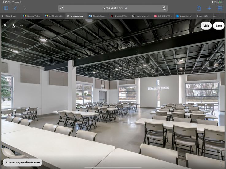 an empty room with tables and chairs in it