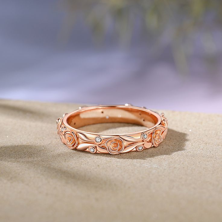 This ring features a captivating design of delicately carved rose blossoms and leaves, evoking a sense of romance, beauty, and elegance. Wearing the ring is a celebration of the beauty and complexity of nature, a reminder of the eternal cycle of growth, bloom, and renewal. Let the enchanting design of the ring inspire you to embrace the beauty around you and to cherish the moments of love and joy in your life.Carat Weight: 0.14 ctStone Size: 1 mmStone Type: Jeulia® StoneNumber of Stones: 14 Ston Elegant Floral Rings With Rose Details, Elegant Rose Design Promise Ring, Elegant Rose-colored Flower Ring For Formal Occasions, Elegant Promise Jewelry With Rose Design, Elegant Promise Ring With Roses Detail, Rose Gold Flower Ring With Rose Design, Elegant Rings With Rose Design, Anniversary Flower Ring With Rose Design, Elegant Flower Ring With Rose Design