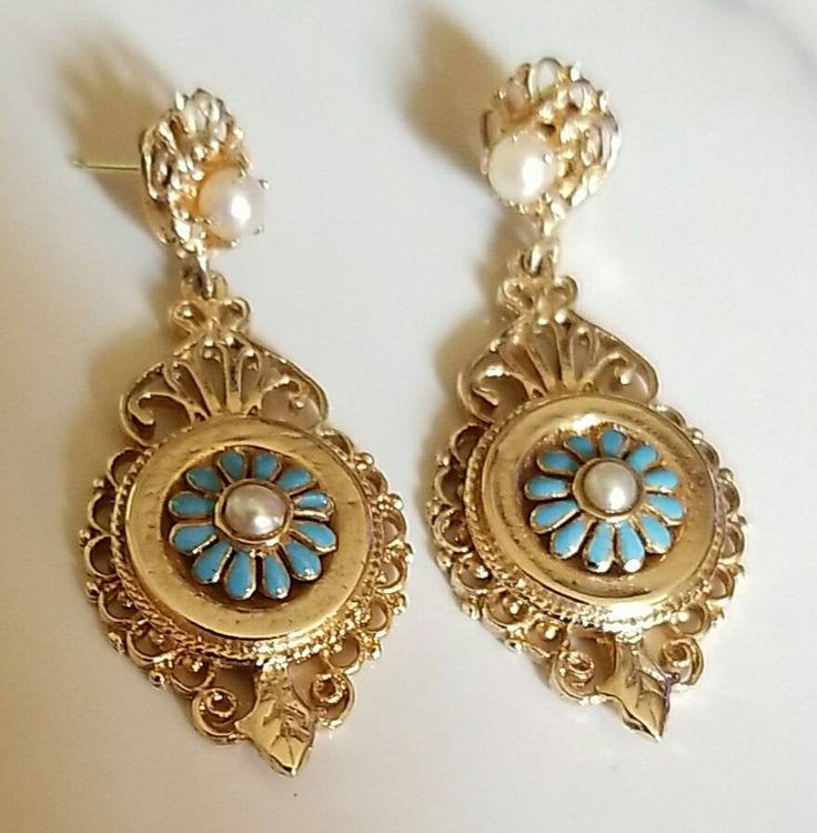 "Pair of 14K yellow gold 19th century Victorian blue enamel and saltwater cultured pearl Victorian dangle style earrings. Attached to the back of each earring is a post and 14K yellow gold friction fit back for fastening. Each earring measures approximately 40.00 mm long and 20.00 mm wide. The saltwater cultured pearls measure approximately 3.00 mm. The pair of earrings weigh 9.90 grams. Stamped \"14K\". The pair of earrings are in beautiful condition. The earrings come in a quality earring box. Victorian Hallmarked Jewelry For Opera, Yellow Gold Enamel Dangle Earrings, Victorian Gold Jewelry For Opera, Antique Gold Jewelry For Opera, Victorian Style Drop Pearl Earrings, Yellow Gold Enamel Dangle Jewelry, Victorian Yellow Gold Pearl Earrings For Gift, Victorian Style Yellow Gold Pearl Earrings For Gift, Victorian 14k Gold Jewelry With Matching Earrings