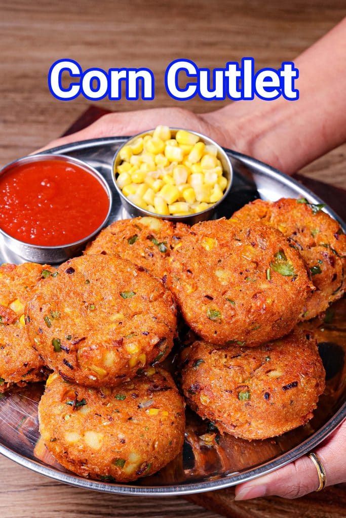 a person holding a plate full of corn cutlets and dipping sauces on the side