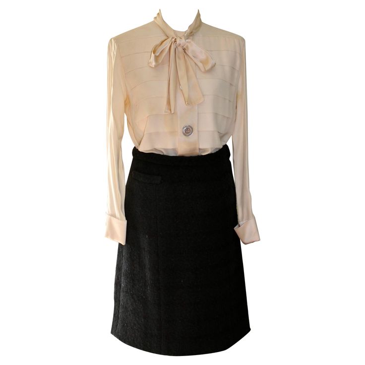 Offering a Silk Blouse and Wool Skirt ensemble. Skirt is 100% thick wool with a horizontal weave, and an all silk lining. Small pocket on right front. Skirt waist 28", length 22" approximate size 38-40. Cream white blouse with bow, three large mother-of-pearl buttons on front of blouse and one on each cuff. Length of blouse 26", sleeve 23". Approx EU size 38-40. Formal Silk Skirt For Fall, Elegant Formal Wool Skirt Suit, Elegant Wool Skirt Suit For Formal Occasions, Luxury Silk Skirt For Workwear, Luxury Silk Skirt For Work, Silk Skirt For Workwear In Fall, Fall Silk Skirt For Work, Silk Workwear Skirt For Fall, Elegant Wool Skirt For Formal Occasions