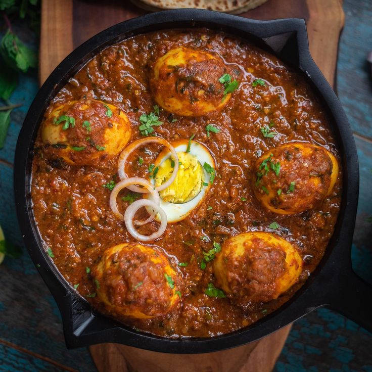 a skillet filled with meatballs and onions