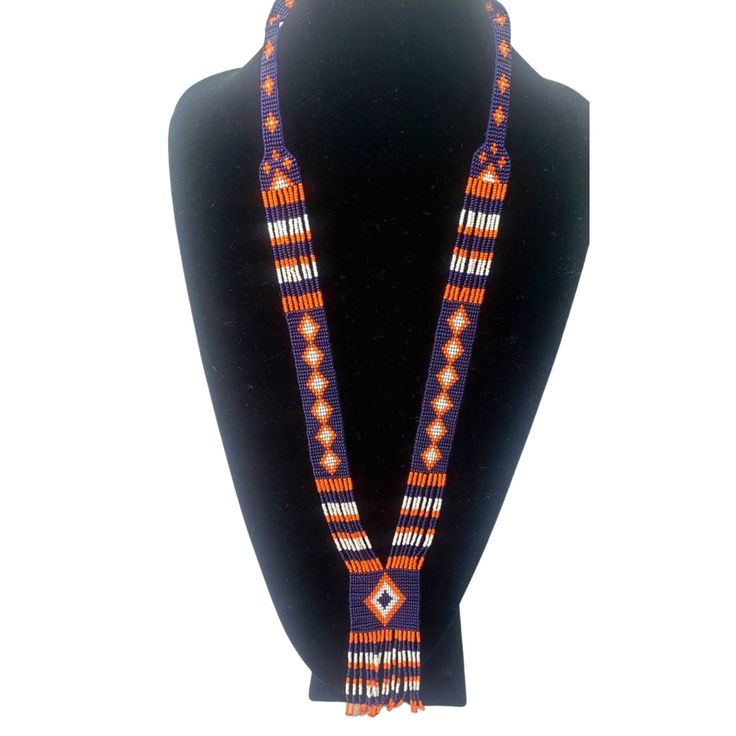 Colorful long seed bead Native American necklace with fun fringe in a striking pattern. This necklace says summer, beach, resort. Necklace measures 16 inches, pendant measures 4 1/2 inches from top to the bottom of the fringe. No clasp, just slip over your head. Striking with a swingy beach dress or a jean jacket. Shop more necklaces here: https://www.etsy.com/shop/BoutiqueByMaryam?section_id=21694658 Be sure to visit the rest of my shop here: https://www.etsy.com/shop/boutiquebymaryam Hand-strung Multicolor Beaded Lariat Necklace, Handmade Southwestern Orange Beaded Necklaces, Artisan Hand-strung Lariat Beaded Necklaces, Bohemian Lariat Beaded Necklaces With Colorful Beads, Handmade Southwestern Orange Necklace, Bohemian Lariat Beaded Necklace With Colorful Beads, Handmade Lariat Necklace With Round Beads For Festivals, Handmade Orange Southwestern Necklace, Orange Bohemian Hand-strung Beaded Necklace