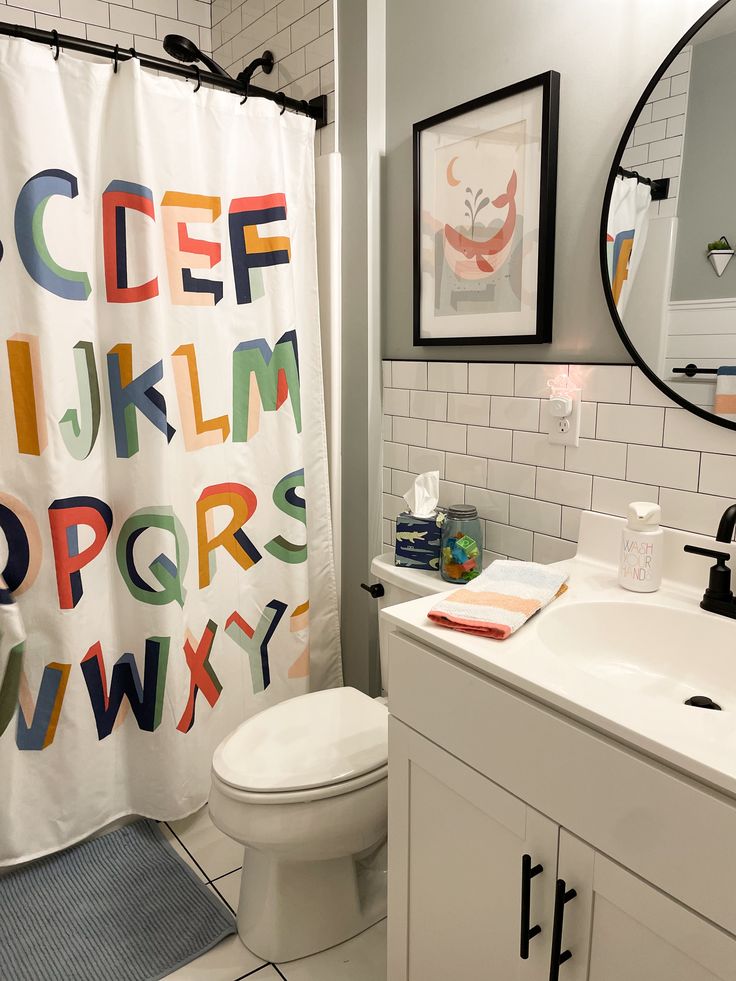 a bathroom with a toilet, sink and shower curtain