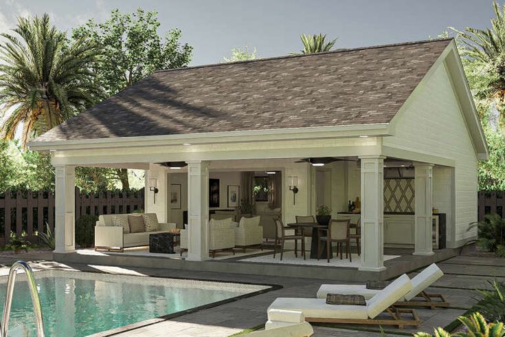 a house with a pool and lounge chairs next to it