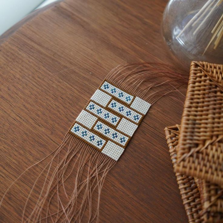 a wooden table topped with woven items on top of it