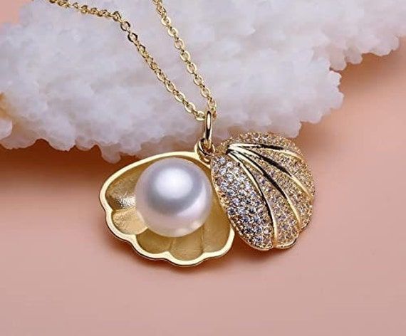 Pearl Necklace Pendant For Girls Women girlfriend Wife Rose gold chain Necklace diamond Pendants chains western Valentine gifts Birthday   * Material: This gold-plated jewellery set is made from Pearl, Diamond and with genuine plating, we used world-class craftsmanship. This is a party wear necklace with gold plated and alloy material, exclusive design that suits best on all types of occasions   * Quality: This beautiful jewellery set is handcrafted with good-quality material. This necklace set is comfortable to wear and perfect for any occasion like wedding ceremonies, parties, birthdays, holidays, and anniversaries   * Package Contains: This package contains a beautifully designed necklace with earrings. You can wear it with a dress, suit, or sari and lehenga for an ethnic yet classy loo Luxury Silver Charm Necklaces Gold Plated, Luxury Gold Plated Silver Charm Necklaces, Gold Cubic Zirconia Jewelry Sets With Clavicle Chain, Fine Jewelry With Clavicle Chain In Diamond White, Fine Jewelry With Diamond White Clavicle Chain, Gold Cubic Zirconia Chain Necklace For Wedding, Elegant Gold Plated Chain Necklace For Her, Gold Plated White Gold Chain Necklace For Anniversary, White Gold Plated Chain Necklace For Anniversary