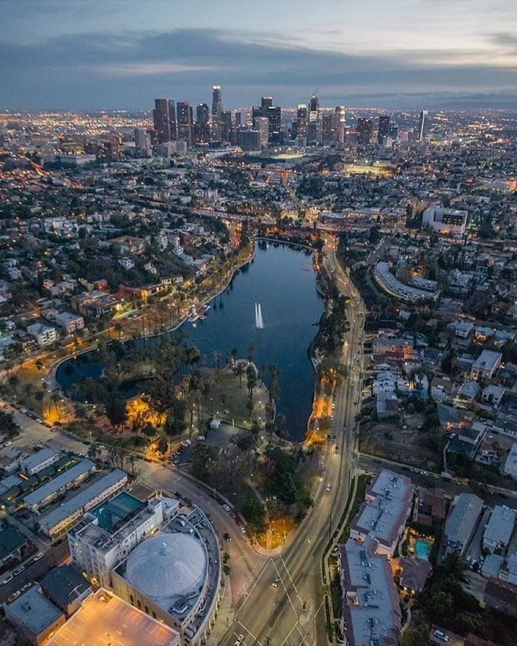 an aerial view of a city with lots of water and buildings in the background at night