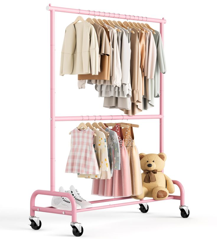 a pink cart with clothes on it and a teddy bear sitting next to the rack