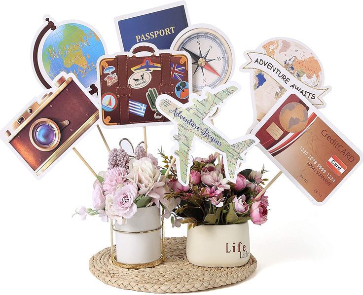 a bouquet of flowers sitting on top of a white vase filled with cards and magnets